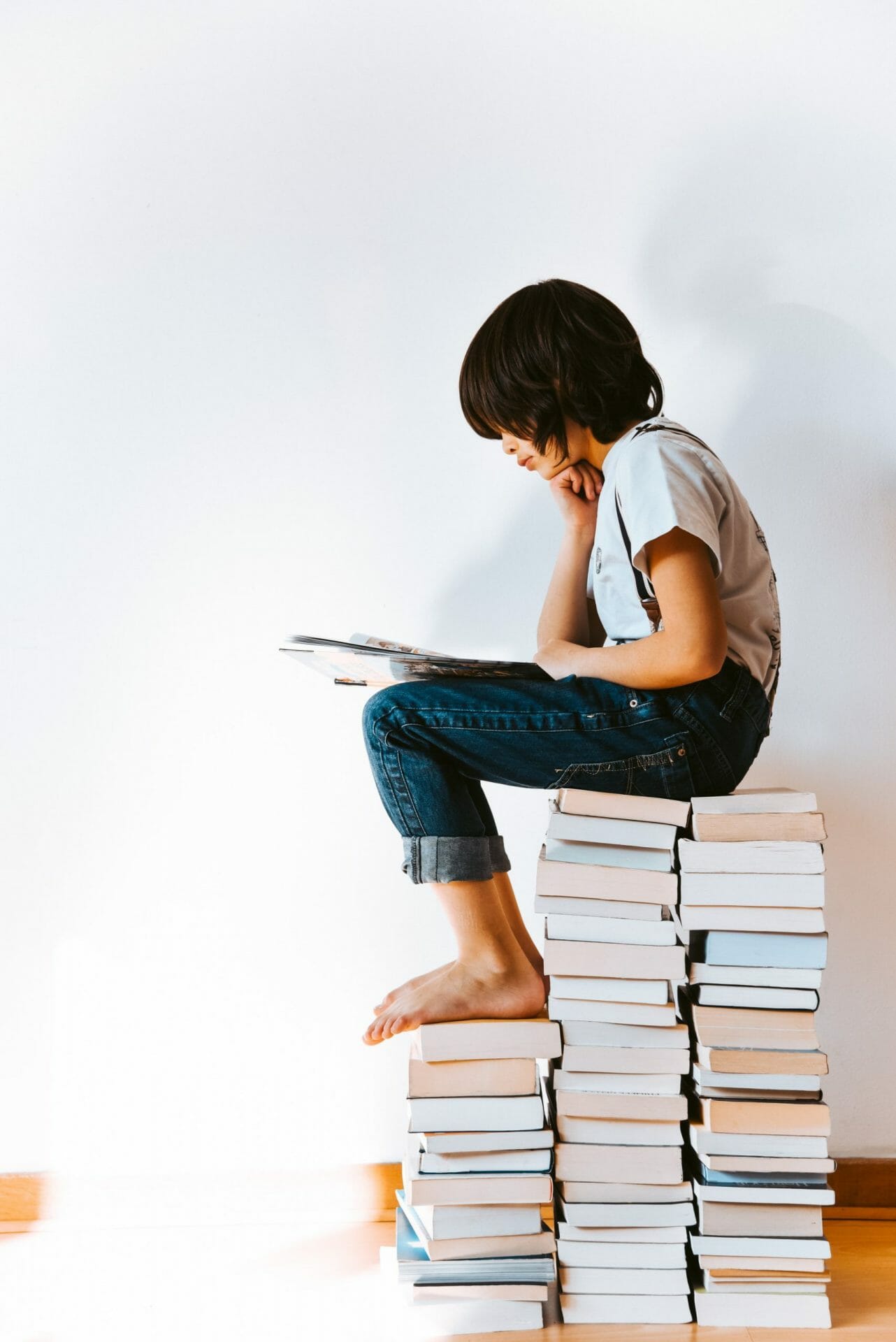 Girl sitting on books