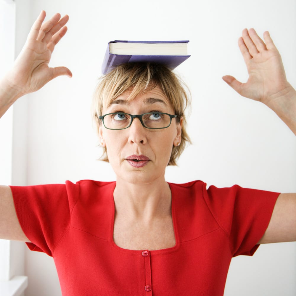 Balancing a book on the head in an attempt to improve posture