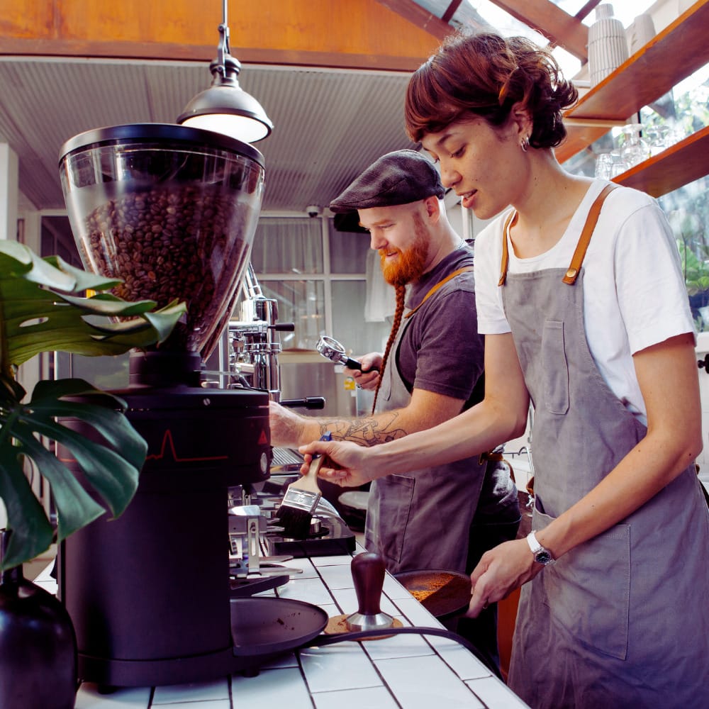 Barristas at coffee machines