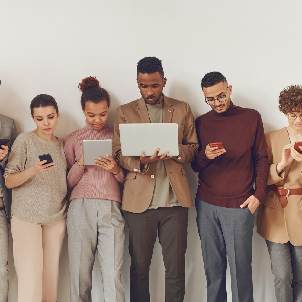 Group standing looking down at devices